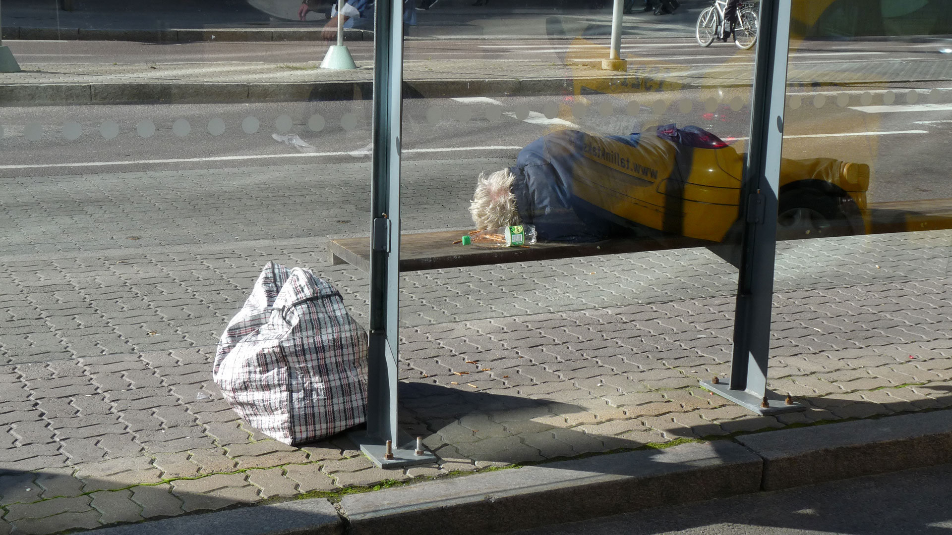 Homeless man sleeping on bench