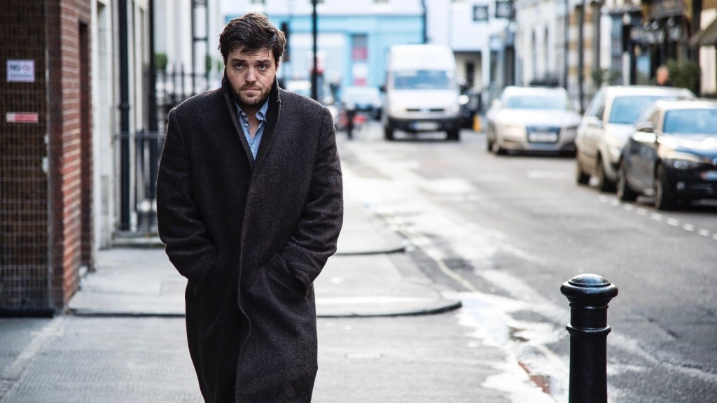 Tom Burke plays Cormoran Strike