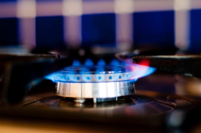 a side-on view of a gas hob which has been lit