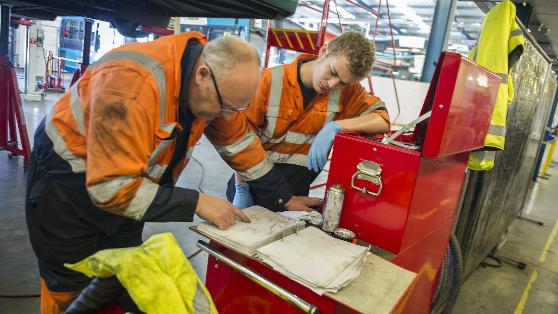 An apprentice engineer studies charts with his supervisor