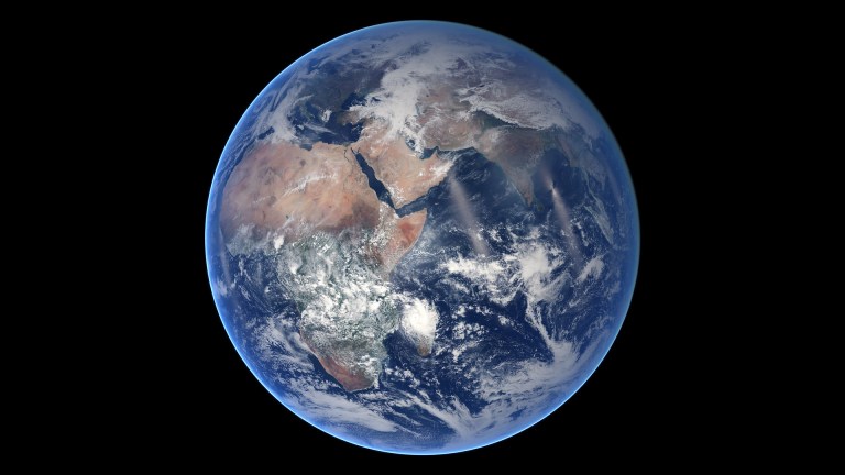 The earth hangs in space, with africa and the middle east visible