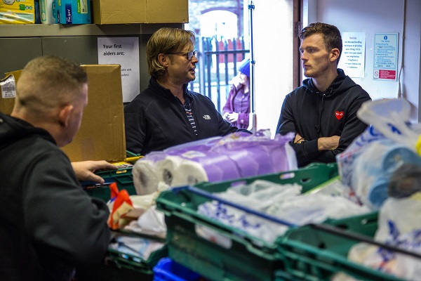 Andy Robertson talks with food bank workers in Liverpool