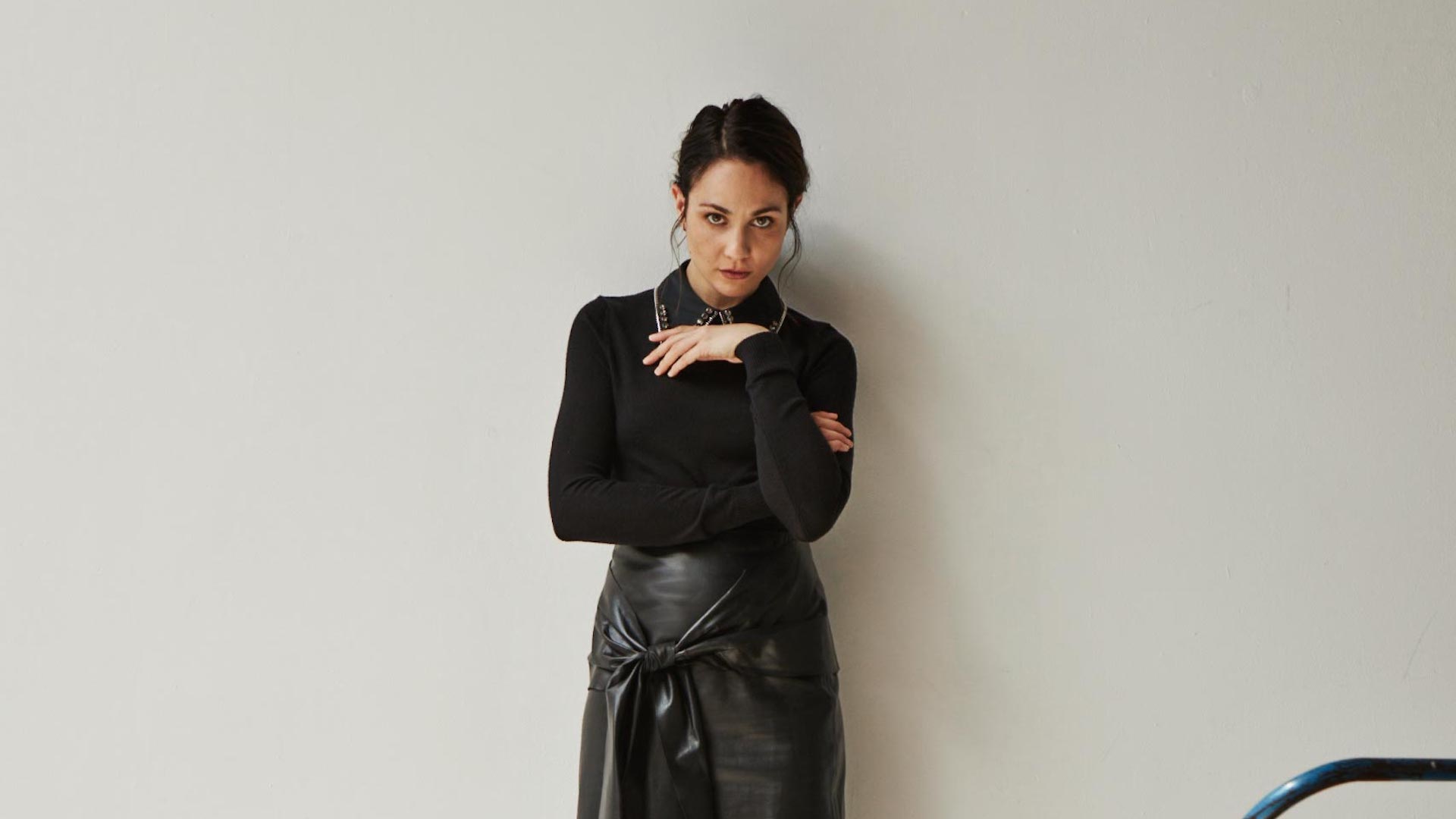 Tuppence Middleton stands wearing all black against a white background