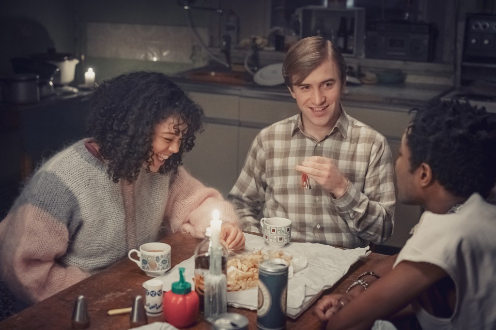 Jill, Colin and Roscoe, played by Lydia West, Callum Scott Howells and Omari Douglas, share a laugh at home in It's a Sin