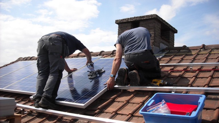 Workers installing solar panels on a roof. Experts told the Government green jobs are key in rebuilding from Covid