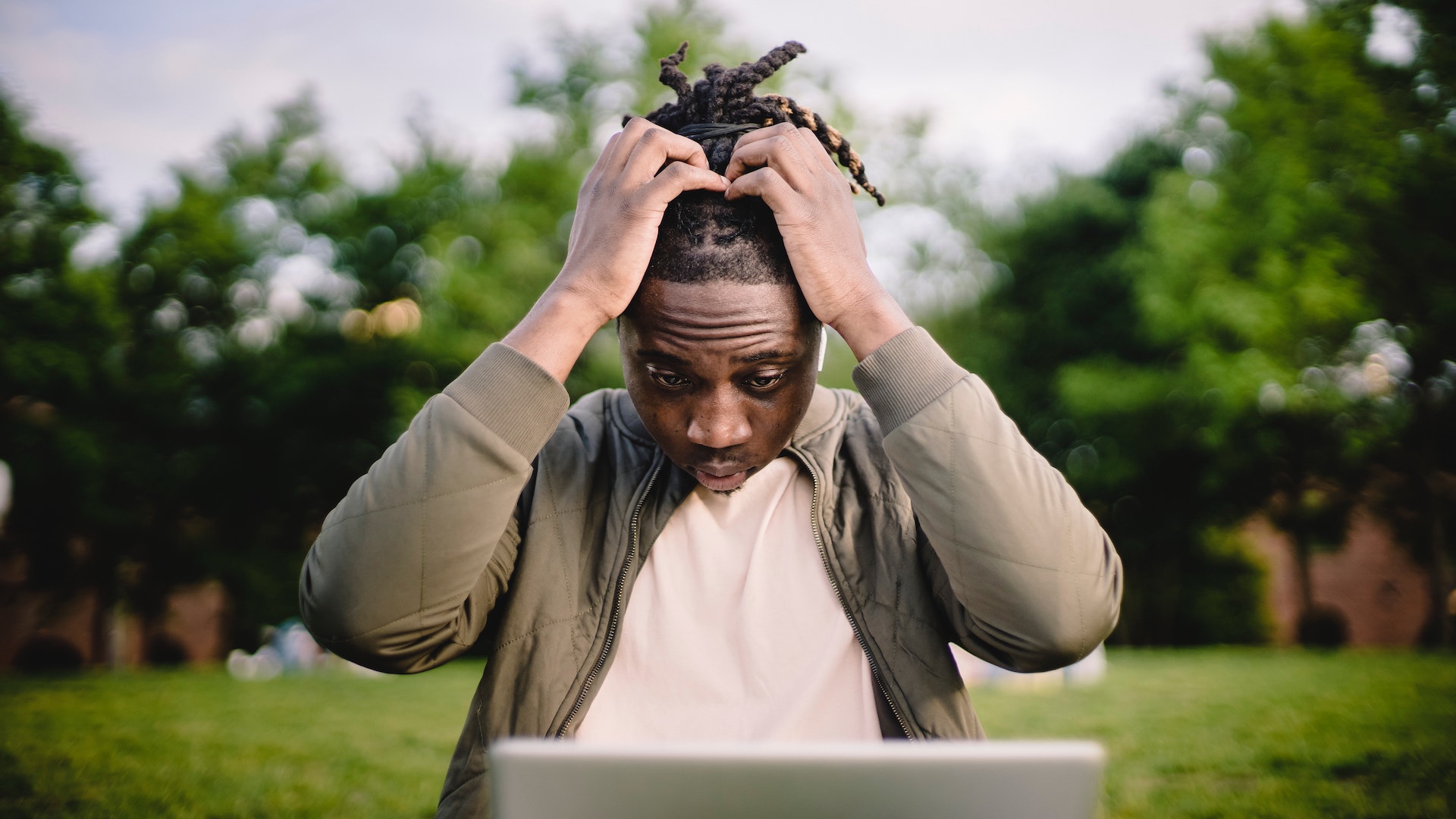 A man looking at a laptop, worried, with his hands on his head. Brits in poverty had incomes 20 per cent lower than the poorest households in France before the pandemic.