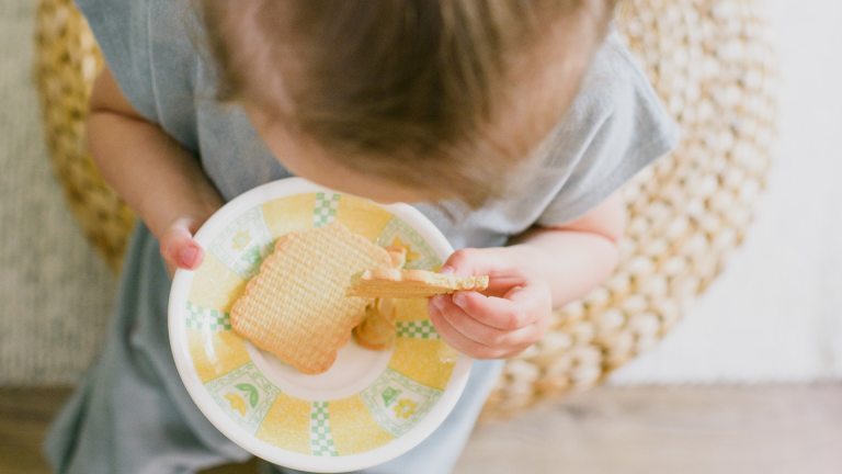 A child eating biscuits. The food banks charity does not expect demand to decrease any time soon, with universal credit set to be cut by £20 per week in September.