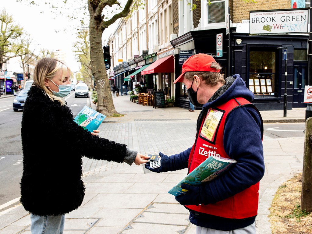 A Big Issue customer pays using the cashless Zettle reader