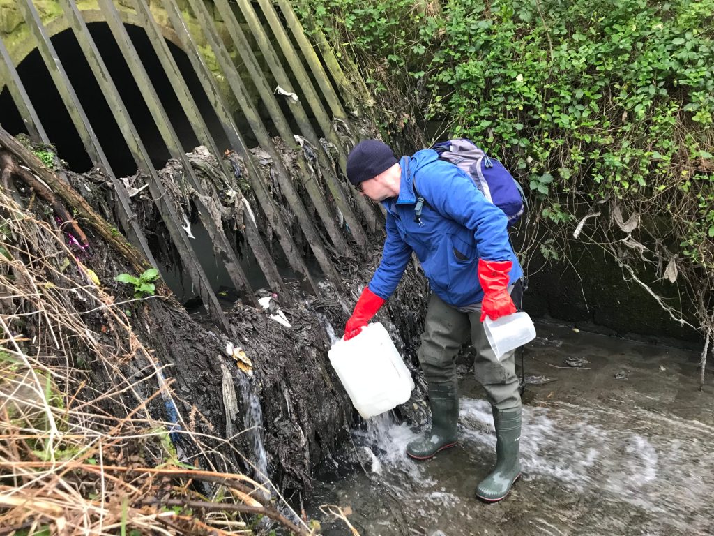 Professor Jamie Woodward sampling effluent from a Combined Sewer Overflow. Image credit: James Rothwell