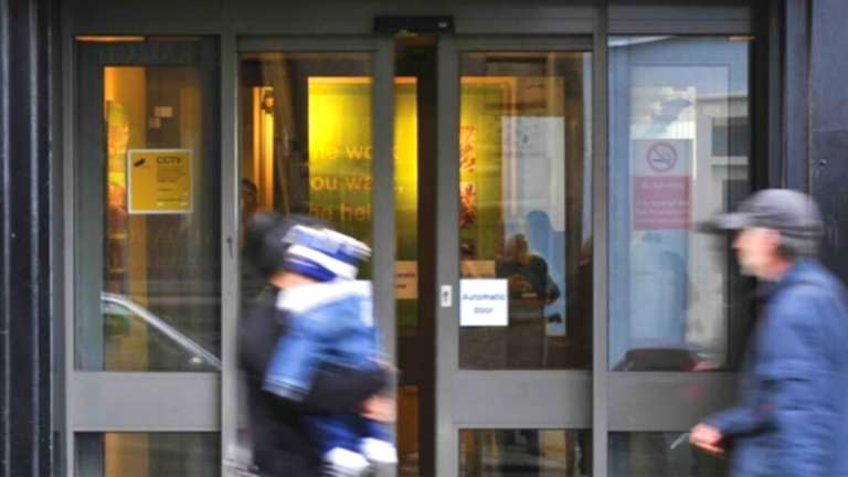 Two people at the Jobcentre. Brits and grappling with financial and mental health impact of unemployment. Image credit: J J Ellison / Wikimedia Commons