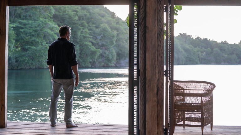 James Bond (Daniel Craig) looks out on the water surrounding his Jamaican home in No Time To Die. Image: Nicola Dove / © 2021 Danjao, LLC and MGM