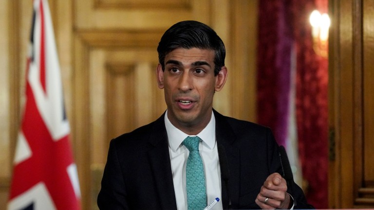 Rishi Sunak, who is making universal credit changes, making an announcement with a union flag behind him