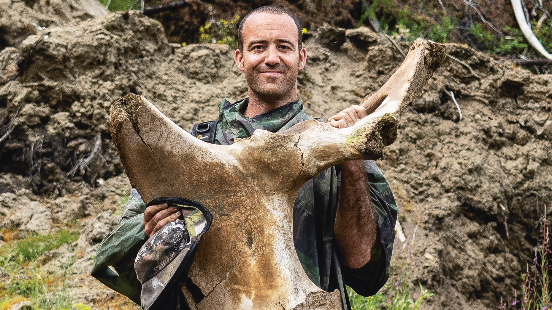 Writer Simon Mundy with a mammoth hip found at an illegal tusk hunting camp in Yakutia, Russia. Image courtesy of Simon Mundy