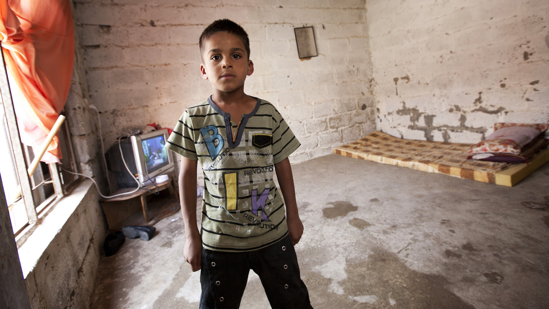 young boy in Iraq displaced by climate change