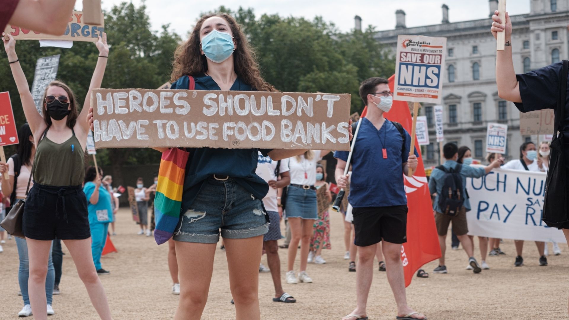 A protestor holds a sign saying "Heroes shouldn't have to use food banks" calling for better pay for NHS workers