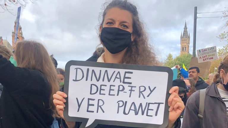 A protester on the youth climate strike with a sign reading