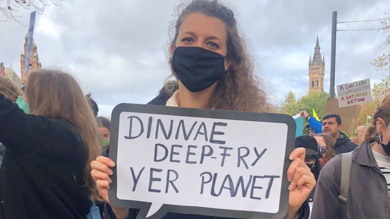 A protester on the youth climate strike with a sign reading 