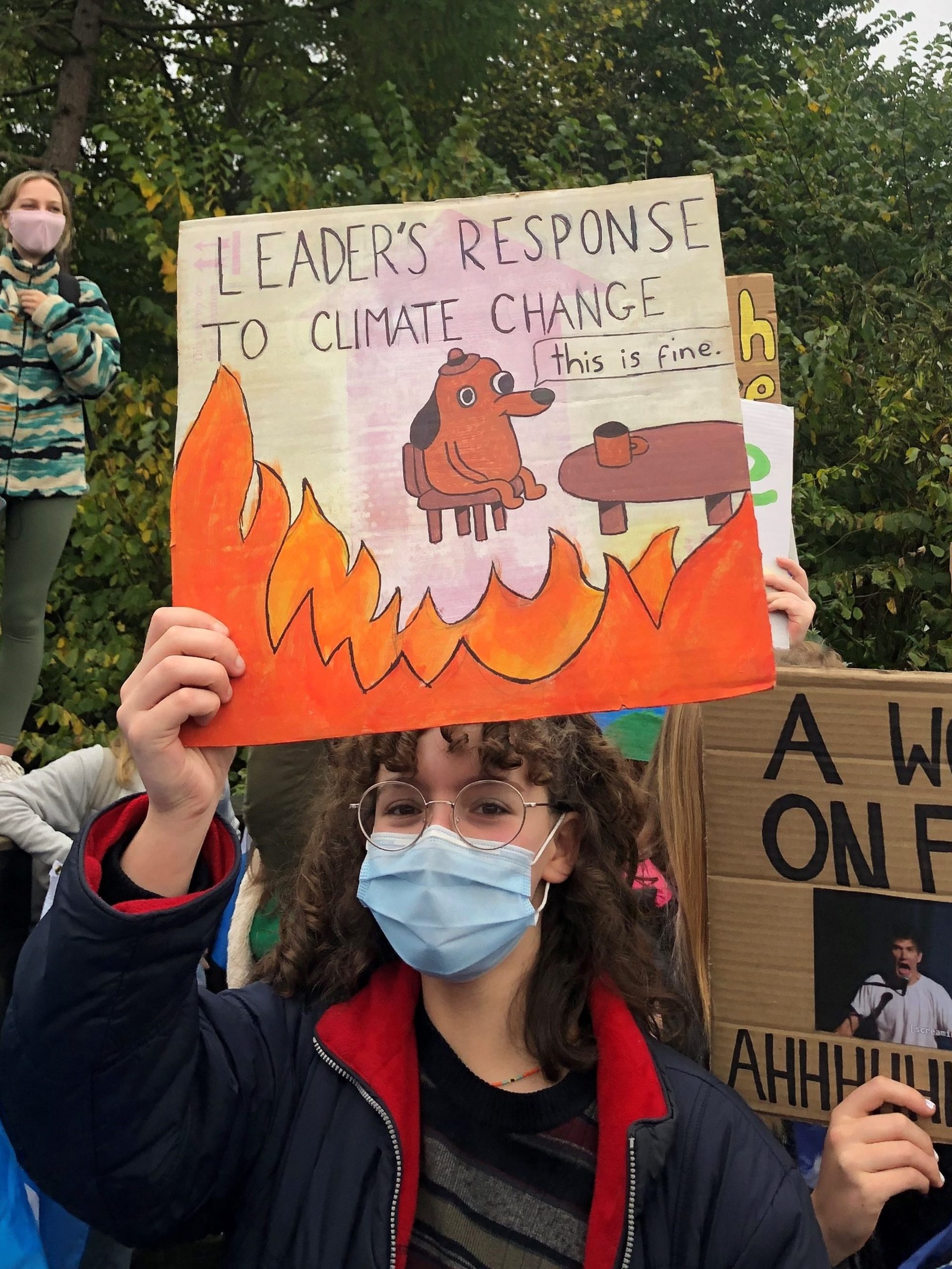 One protester made a sign based on the popular "this is fine" meme. Image: Sarah Wilson