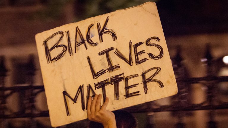 A crowd of community members gather outside the Governor's Residence in Saint Paul, Minnesota, in the 2 a.m. hour on July 7, 2016, following the police shooting of Philando Castile in Falcon Heights, Minnesota, by a St. Anthony Police officer.