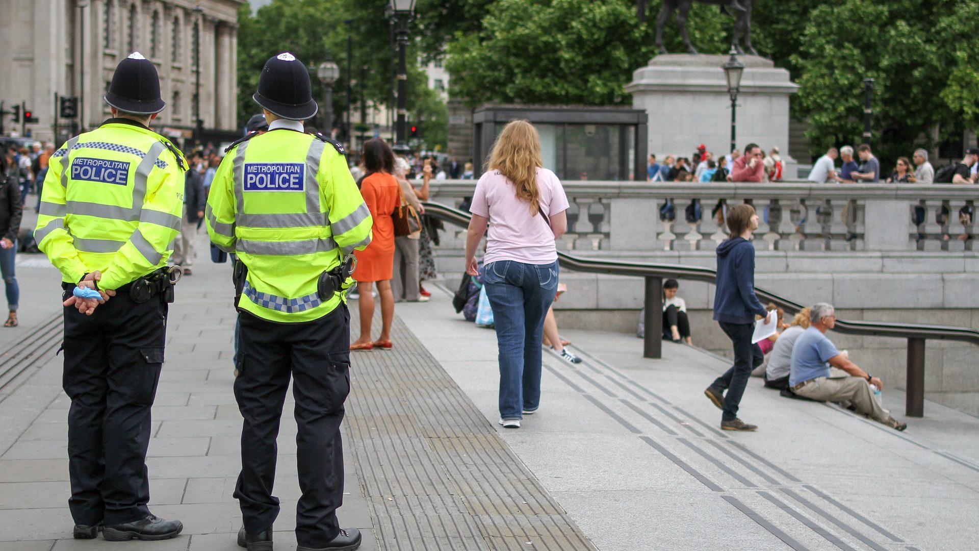 Met Police officers standing by stairs.