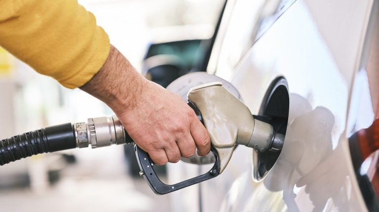 Hand filling car up with fuel.