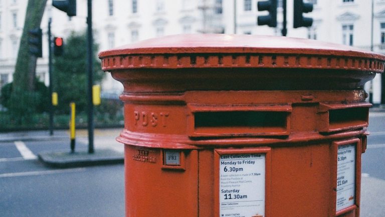 Large Royal Mail post box with traffic lights in the background