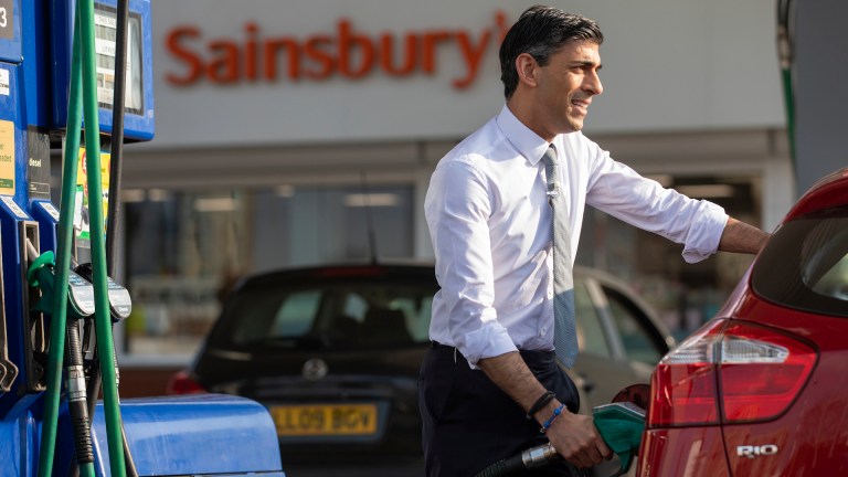 Rishi Sunak posing in front of a sainsbury's, filling an aide's car with petrol