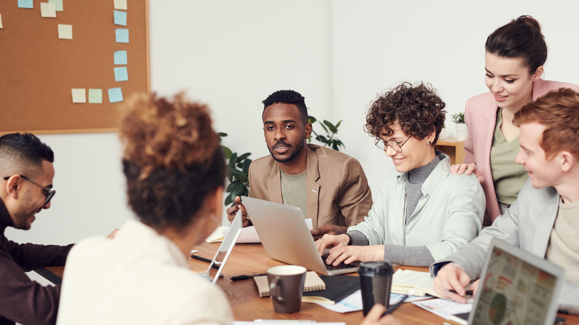 A diverse group of people work together at a table