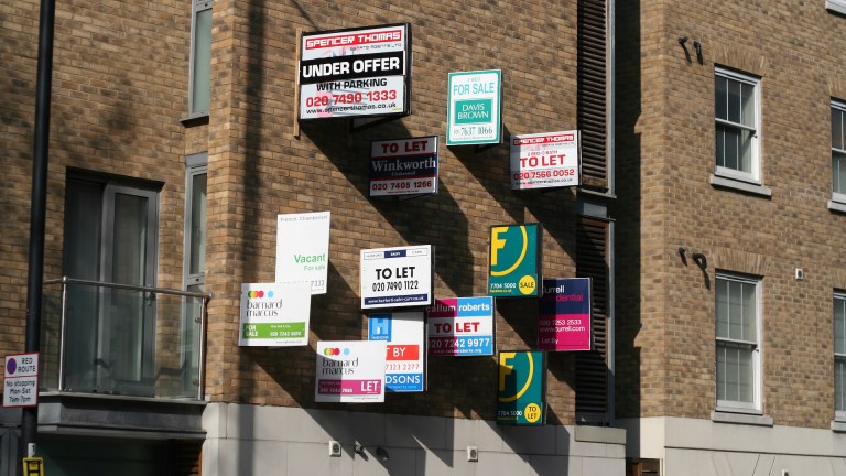 To Let signs fill a wall in King's Cross, London.