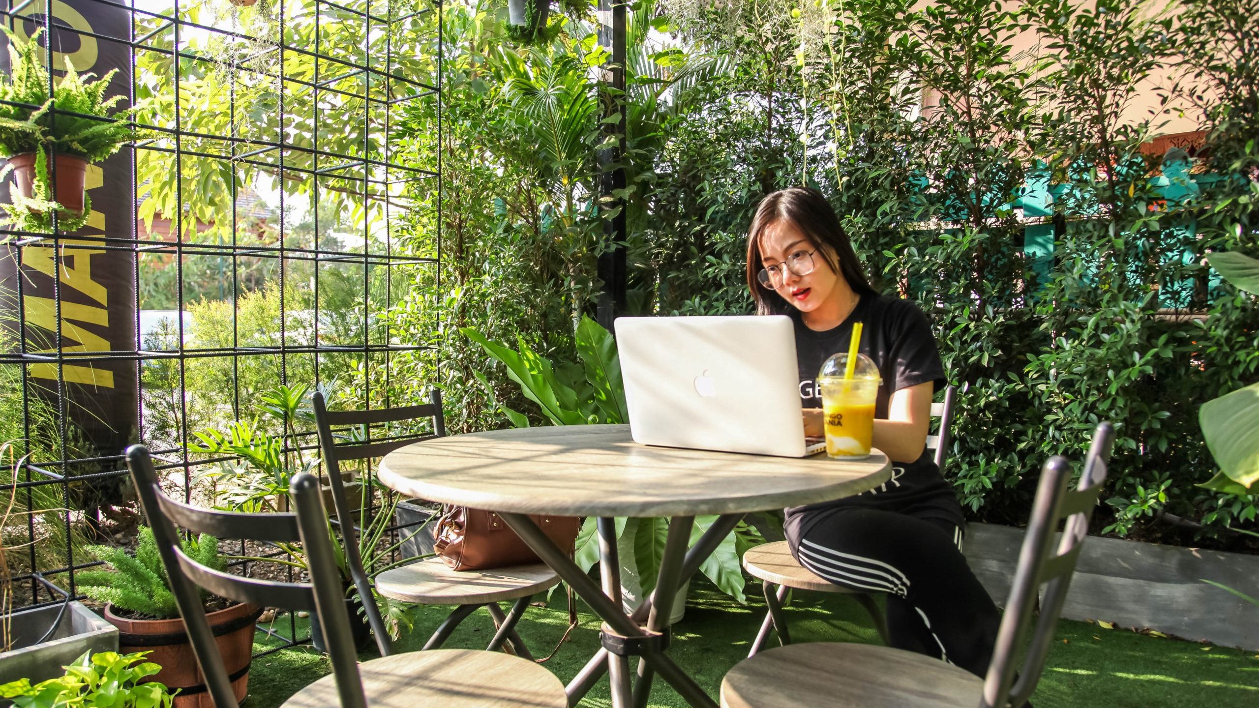 Woman working on laptop in the garden