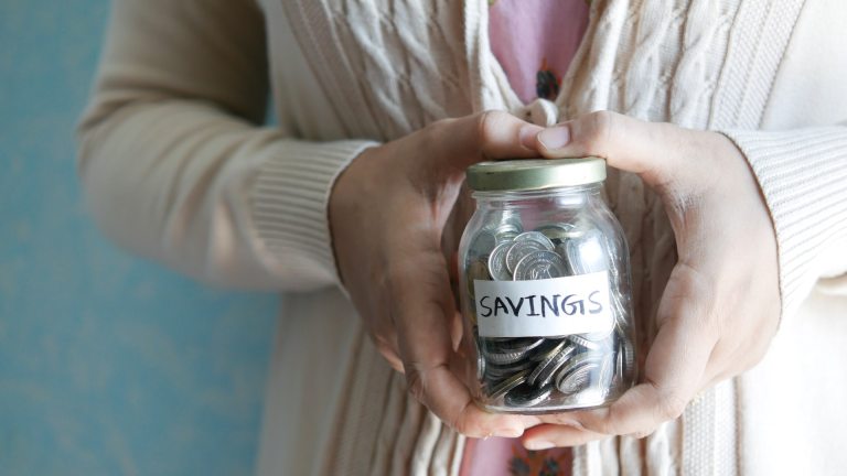 A woman holds a glass jar marked 