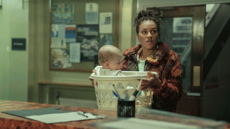 A baby in a laundry basket