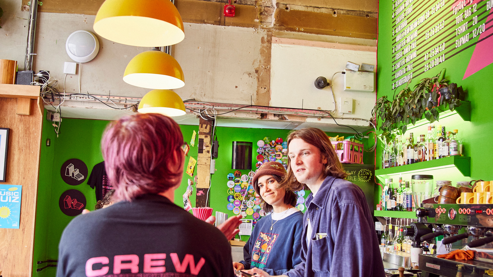 Inside Future Yard in Birkinhead where people are chatting in a cafe