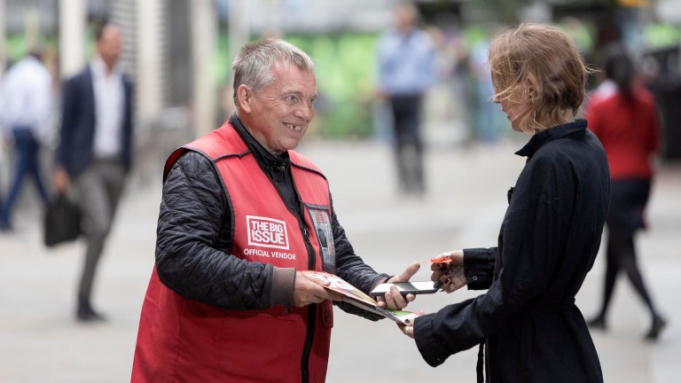 Big Issue vendor Hugh Palmer makes a cashless sale