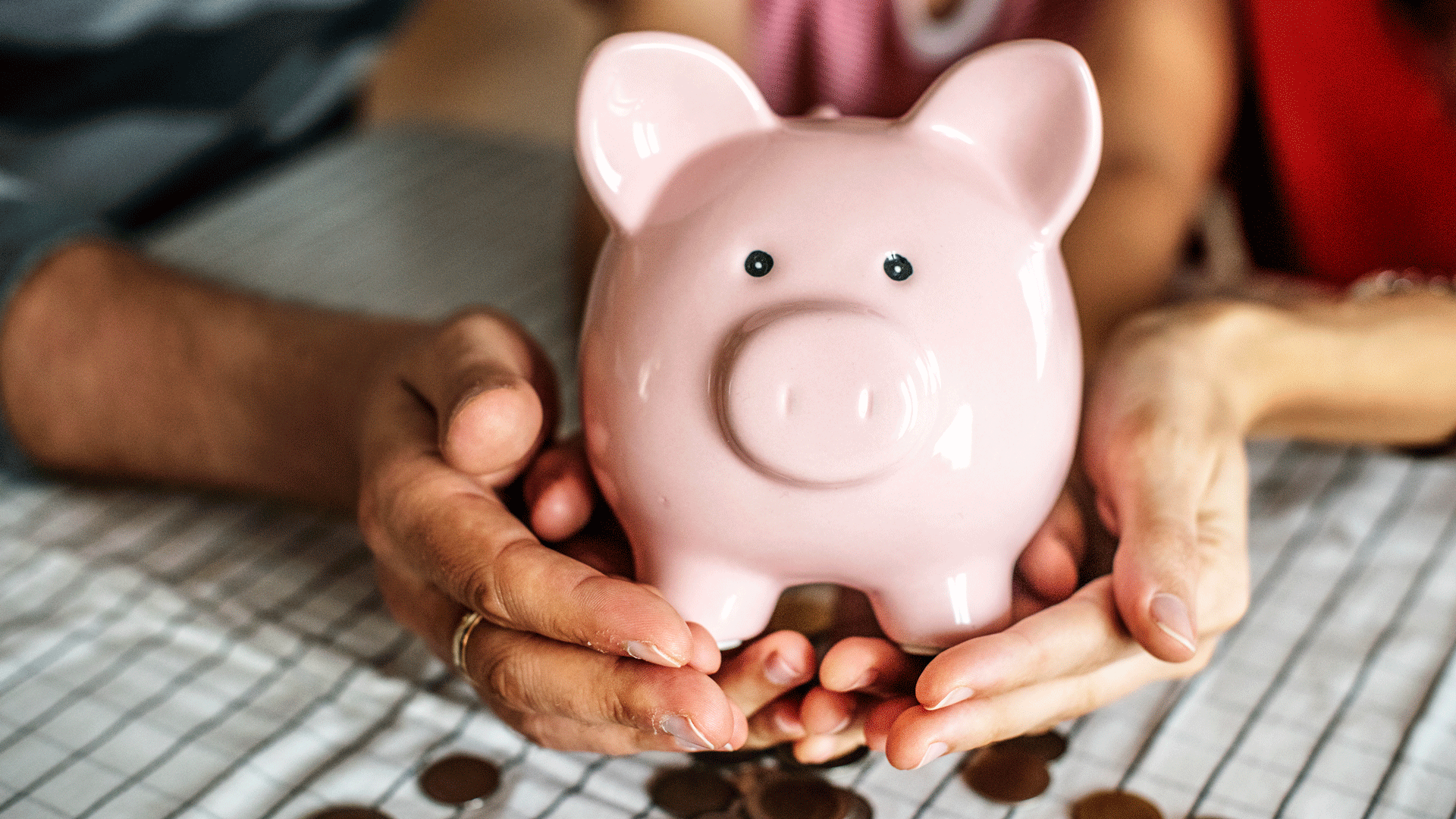 Hands holding a piggy bank