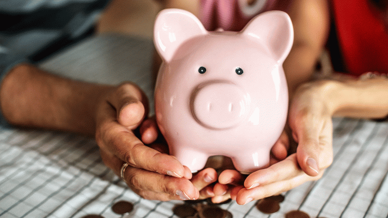 Hands holding a piggy bank