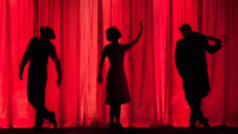 Three silhouettes on stage