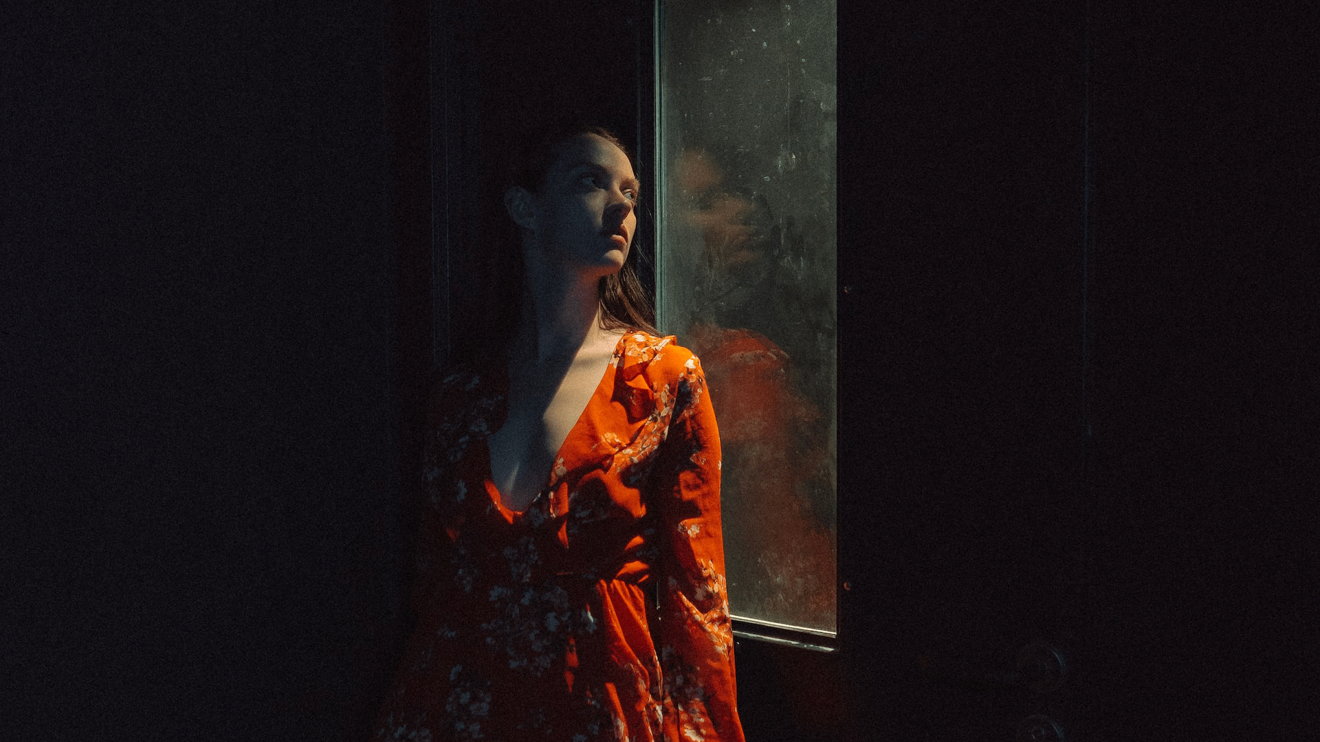 Woman at dark window