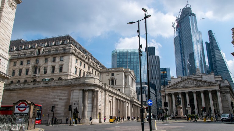 The old Bank of England and new city buildings against the blue London sky