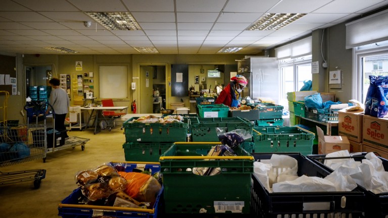 A volunteer sorts food donations at a food bank
