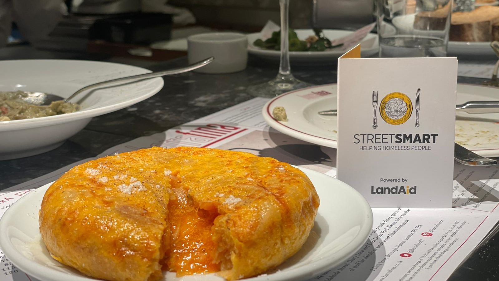 A tortilla and the StreetSmart campaign card in restaurant Barrafina