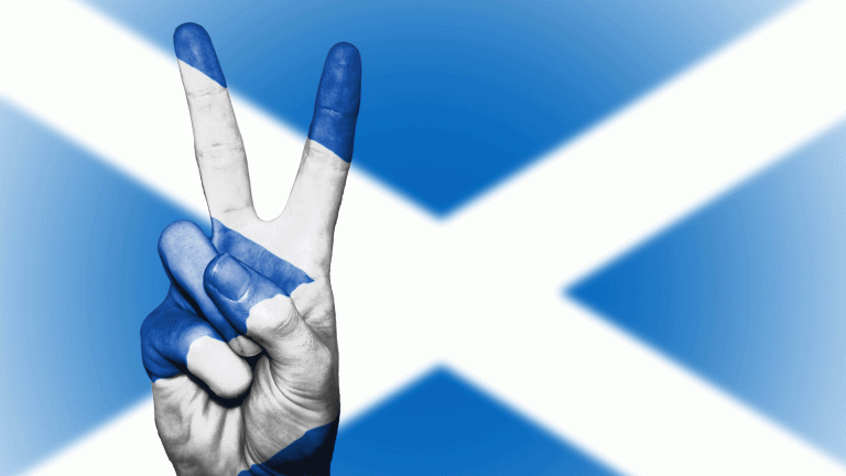 Scotland flag with hand giving peace sign