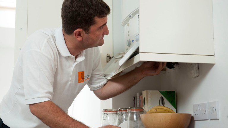 A man fixes a broken boiler