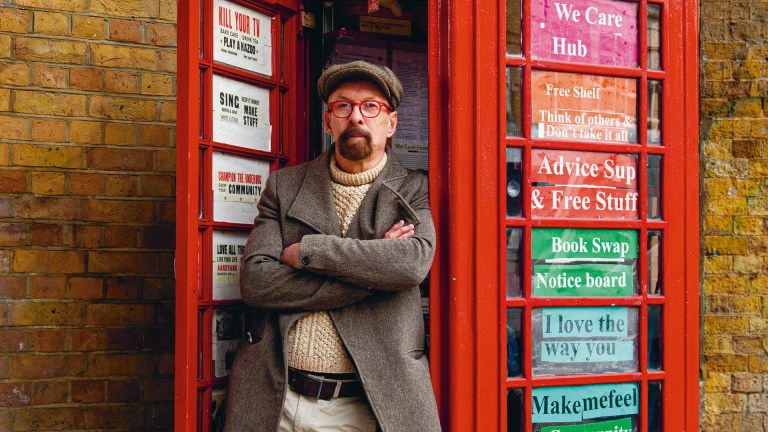 Ray Barron-Woolford at his community hub phonebox