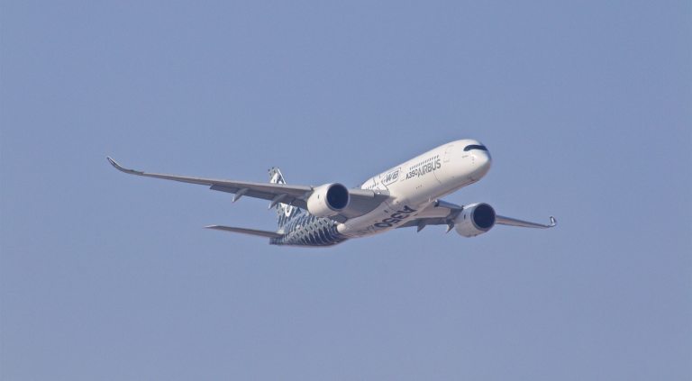airbus plane in the sky releasing carbon emissions