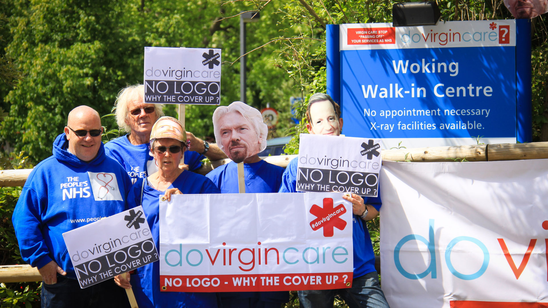 NHS workers protest with placards that say 'Do Virgin Care'