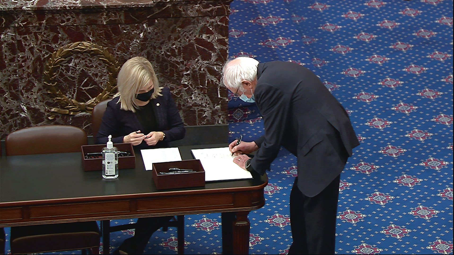 Bernie Sanders signs the oath book for the impeachment trial of Donald Trump, January 2021