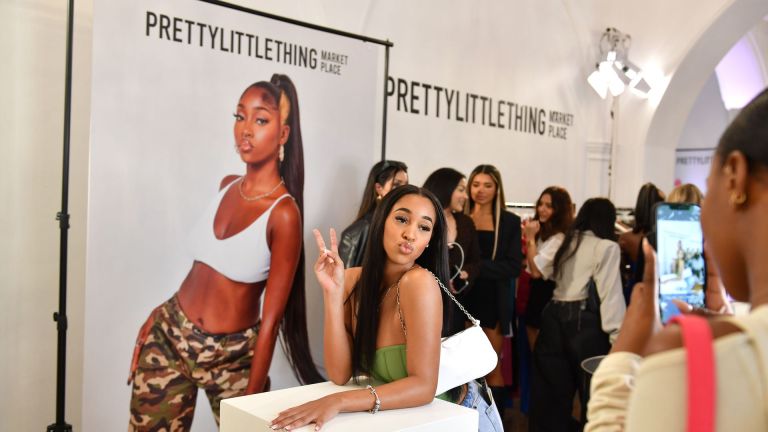 Summer Botwe at the PrettyLittleThing Marketplace launch PrettyLittleThing Marketplace launch in London in September 2022. Indiyah Polack features on the banner behind. Photo by James Veysey/PrettyLittleThing/Shutterstock