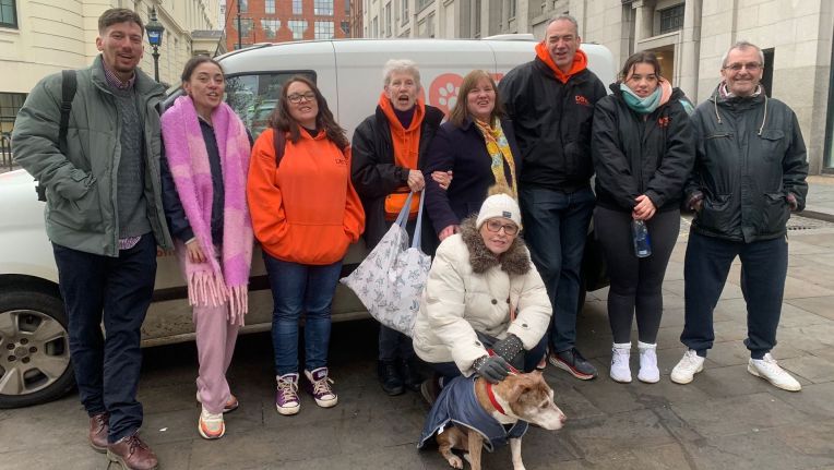 The team from dogs on the streets london stand in front of their van