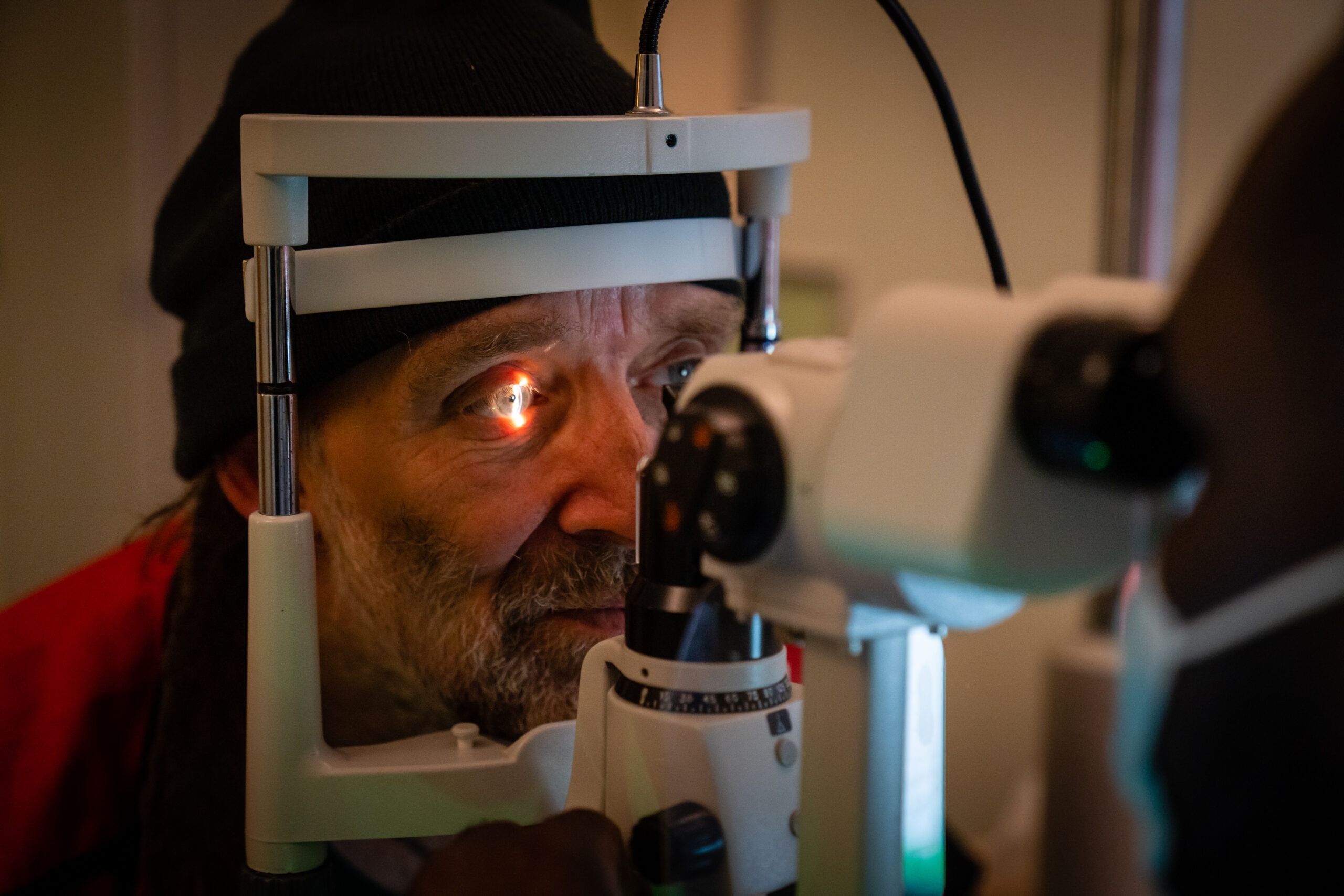 A Big Issue vendor receives an eye test.